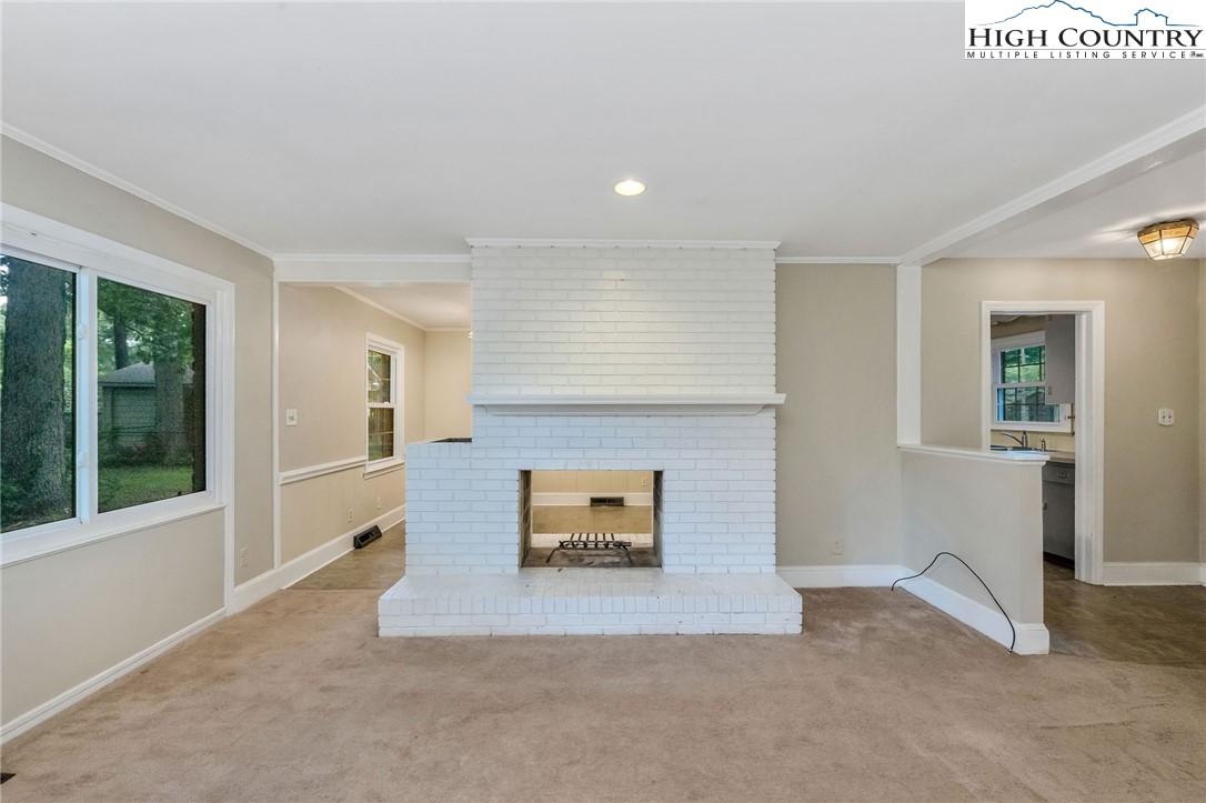 5524 Seacroft Road Charlotte, NC 28210 - Photo 13 of 36 an empty room with windows and fireplace