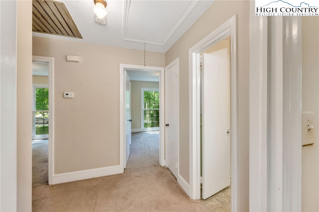 5524 Seacroft Road Charlotte, NC 28210 - Photo 22 of 36 a view of a hallway with wooden floor and a room