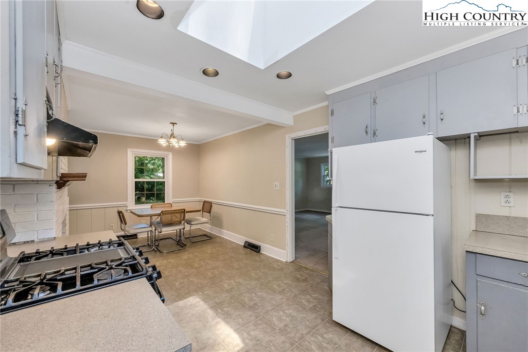 5524 Seacroft Road Charlotte, NC 28210 - Photo 10 of 36 a kitchen with a refrigerator and a stove top oven