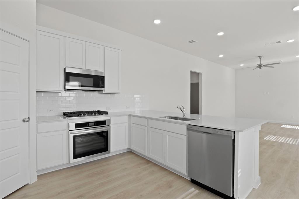 8336 Coastal Lane Pilot Point, TX 76258 - Photo 7 of 17 Kitchen in the Pecan II home plan by Trophy Signature Homes – REPRESENTATIVE PHOTO