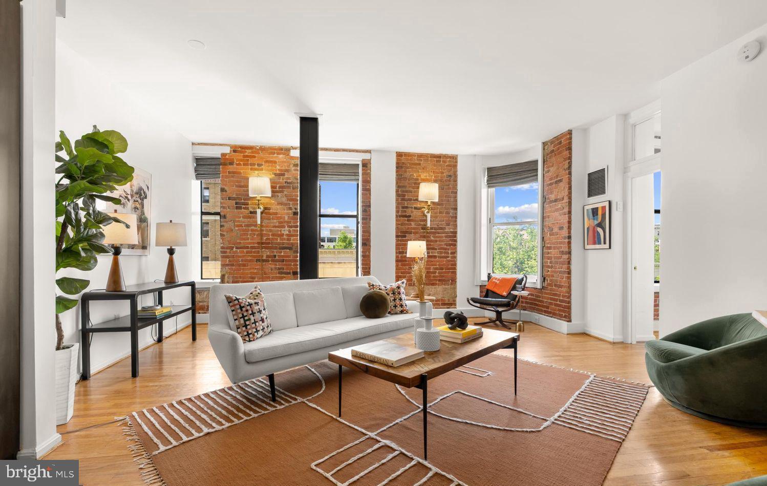 a living room with furniture and a potted plant