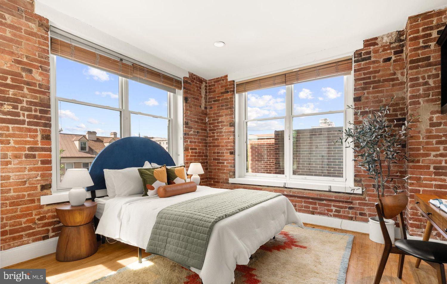 1615 Q Street Northwest, Unit 301/303 Washington, DC 20009 - Photo 11 of 53 a bedroom with a bed and a large window