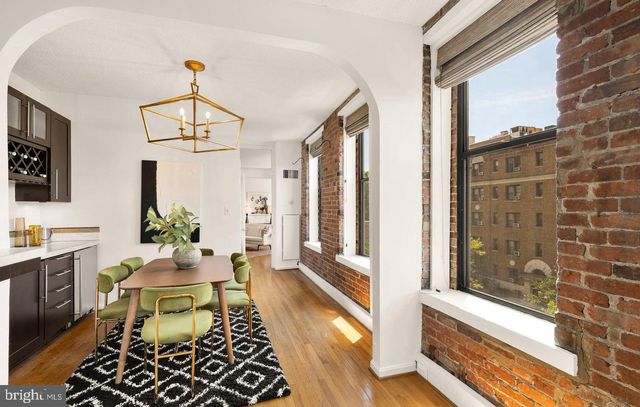 a living room with furniture a window and a chandelier