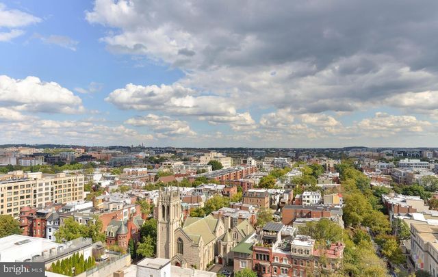 a view of swimming pool with a garden and plants