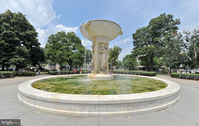 a group of people sitting in front of building