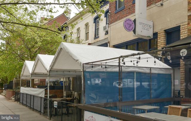 a front view of a building with sitting area