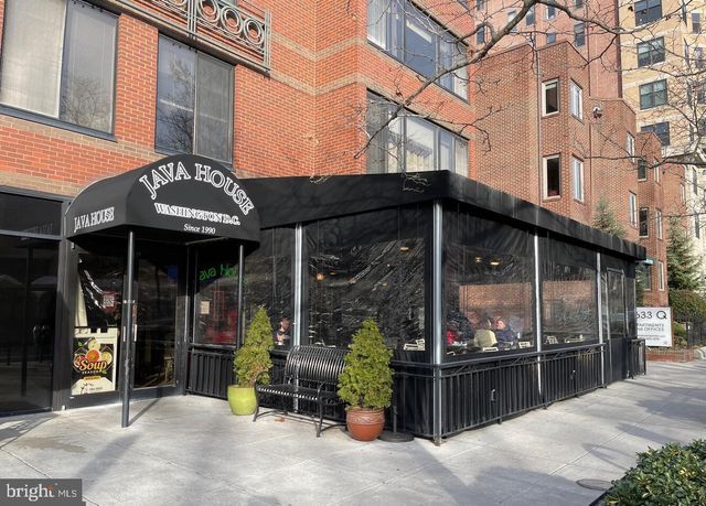 a view of a brick building with a door and wooden floor