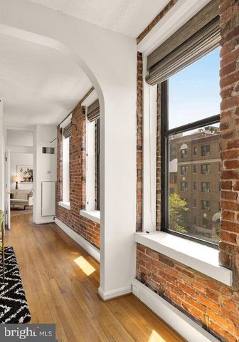 a view of a room with wooden floor and windows