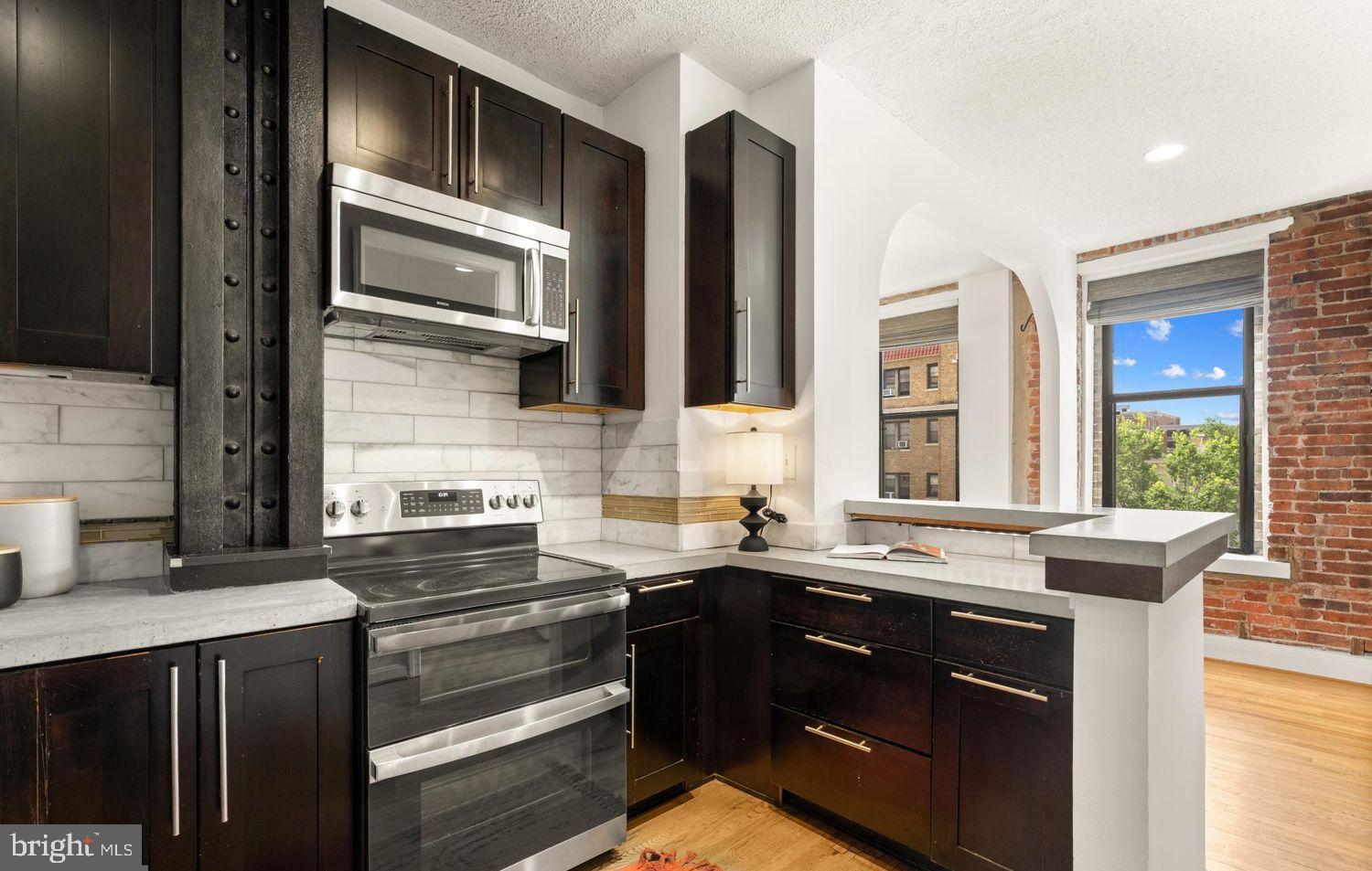 1615 Q Street Northwest, Unit 301/303 Washington, DC 20009 - Photo 10 of 53 a kitchen with stainless steel appliances a sink stove and cabinets