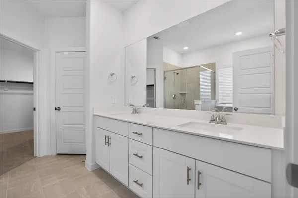 a bathroom with a granite countertop sink a toilet and shower