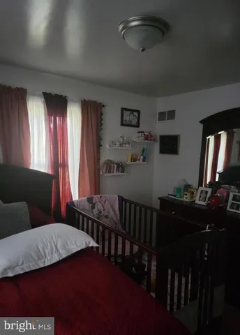 a bedroom with furniture and a window