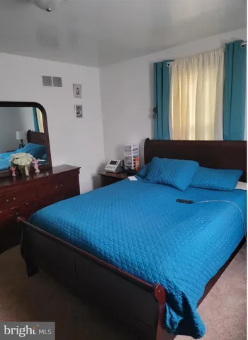 a bedroom with a bed and window