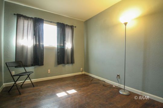 941 West Boston Avenue Ridgecrest, CA 93555 - Photo 13 of 23 a view of an empty room with wooden floor and a window