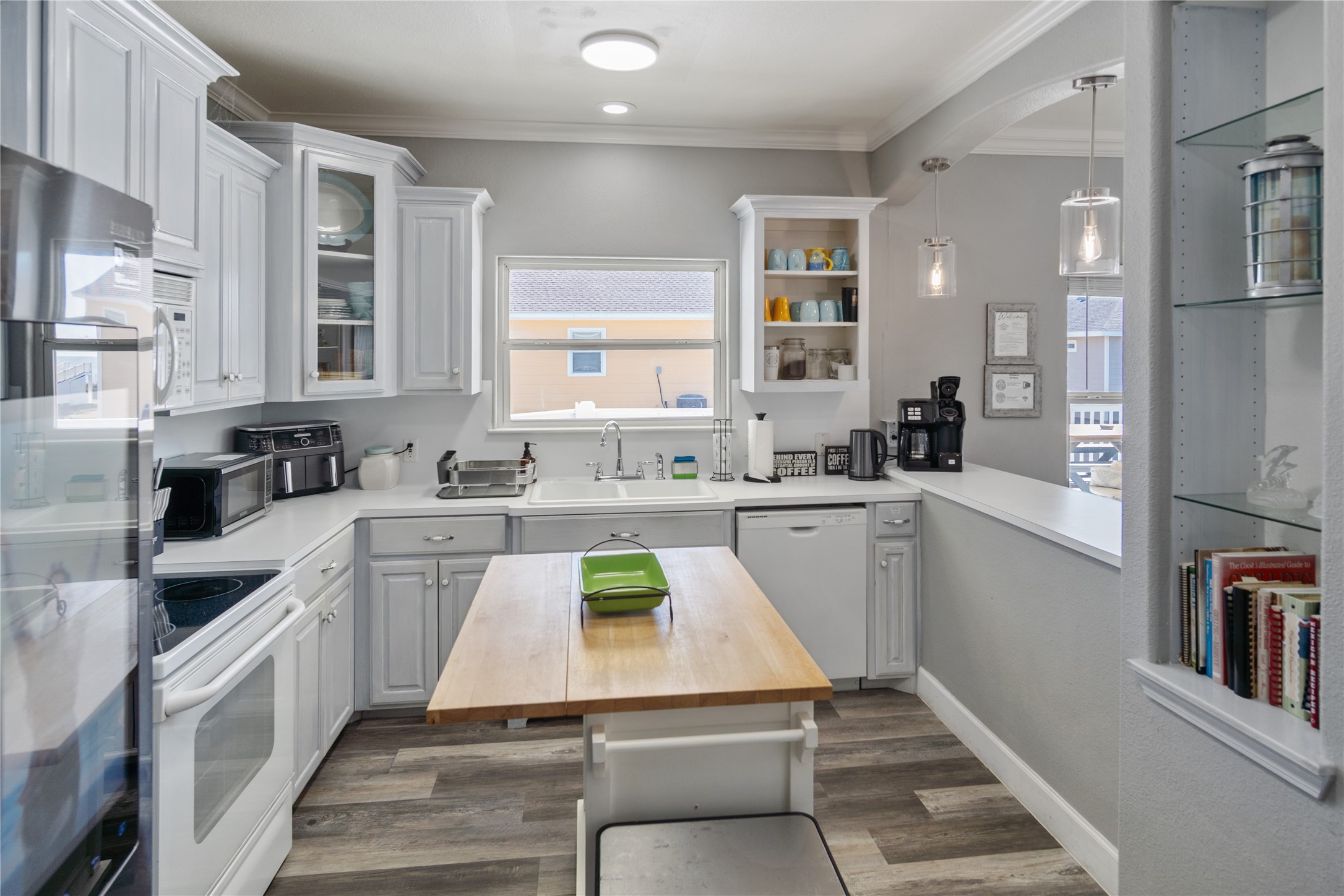2296 Martinique Crystal Beach, TX 77650 - Photo 12 of 49 a kitchen with a sink cabinets and window
