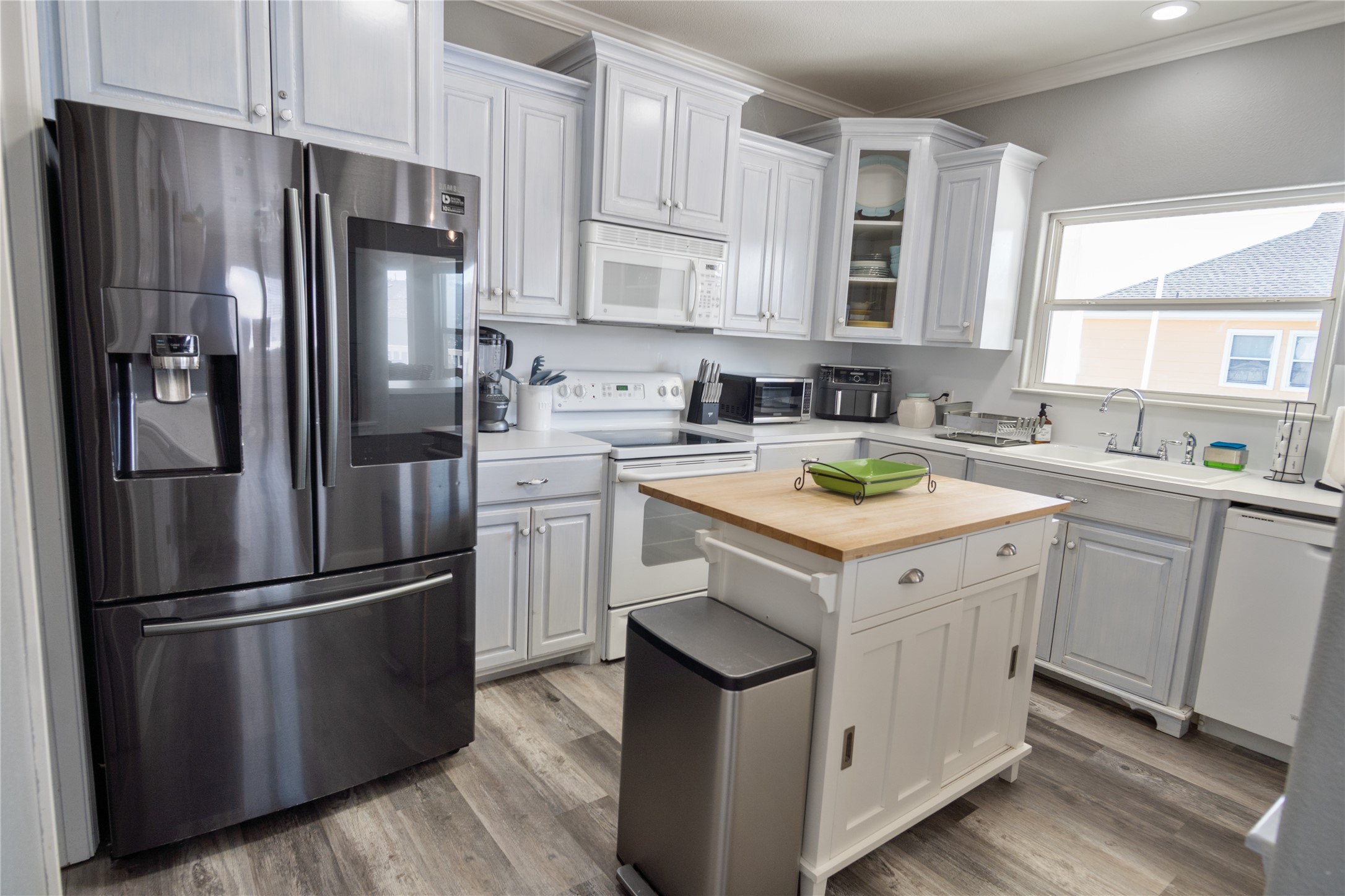 2296 Martinique Crystal Beach, TX 77650 - Photo 15 of 49 a kitchen with a refrigerator sink and cabinets