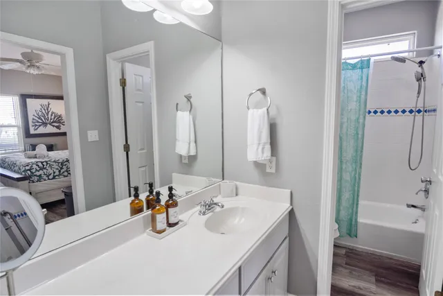 a bathroom with a tub sink and mirror