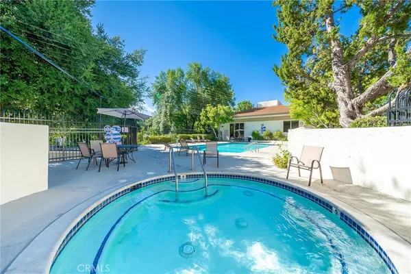swimming pool view with a seating space