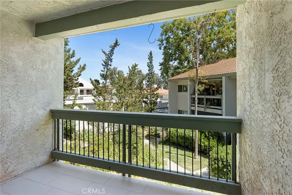 a view of a porch with a floor to ceiling window and wooden fence