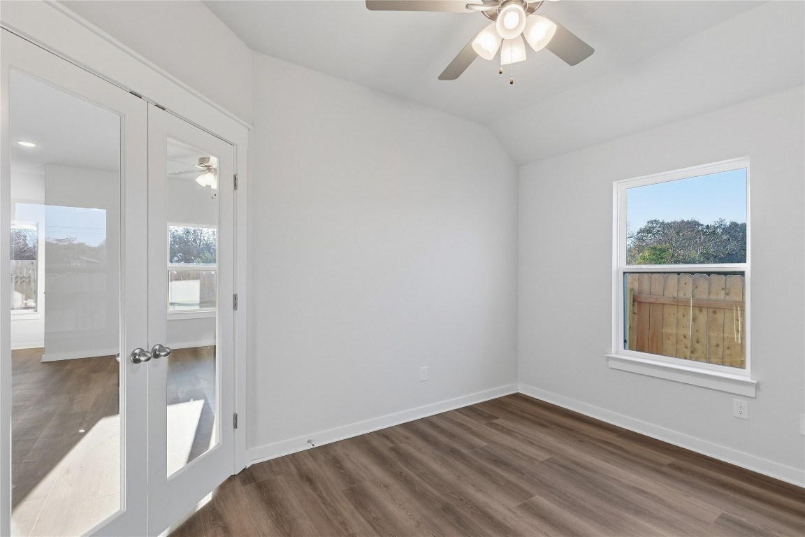 350 Mustang Bend Kyle, TX 78640 - Photo 8 of 18 Empty room featuring french doors, dark wood-style floors, plenty of natural light, and lofted ceiling