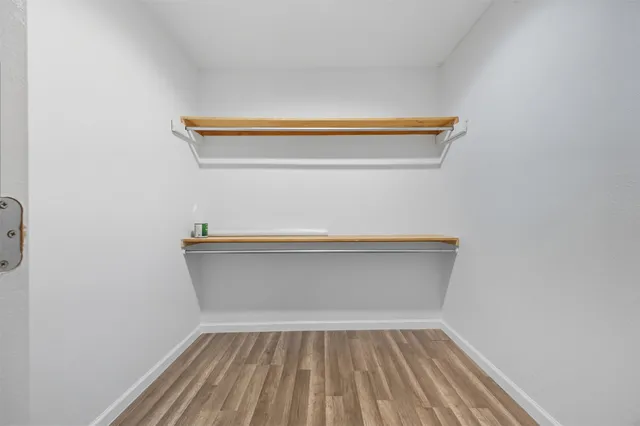 a bathroom with a double vanity sink a toilet and shower
