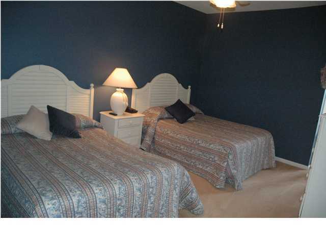 10254 East Hwy Inlet Beach, Unit 13W 30A Inlet Beach, FL 32461 - Photo 9 of 16 a bedroom with a bed and a lamp