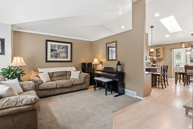 1101 Old Dairy Road Sandy, UT 84094 - Photo 6 of 36 Living area featuring a vaulted ceiling with recessed lighting, neutral carpet, and an open concept layout to the kitchen
