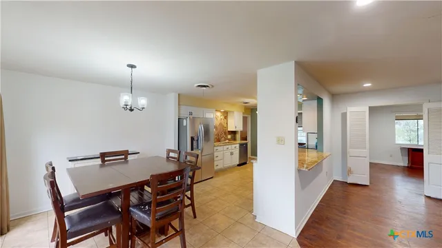 a view of room with wooden floor flat screen tv and windows