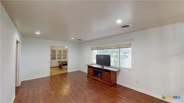 a view of a livingroom with furniture and chandelier fan