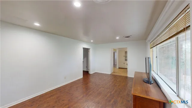 a view of an empty room with a window