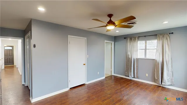 a front view of a livingroom with washer and mirror