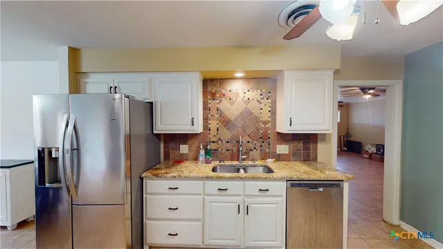 a kitchen with stainless steel appliances a refrigerator and a sink
