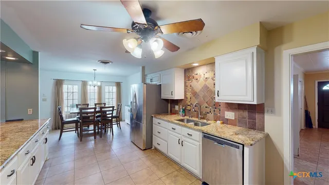 a view of a livingroom with furniture hardwood floor and a ceiling fan