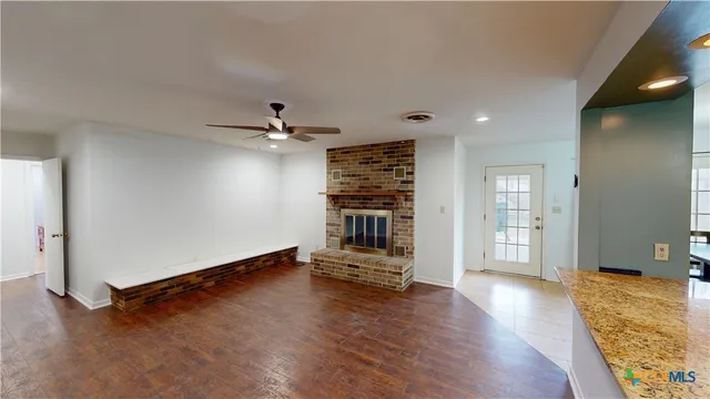 wooden floor in an empty room with a fireplace