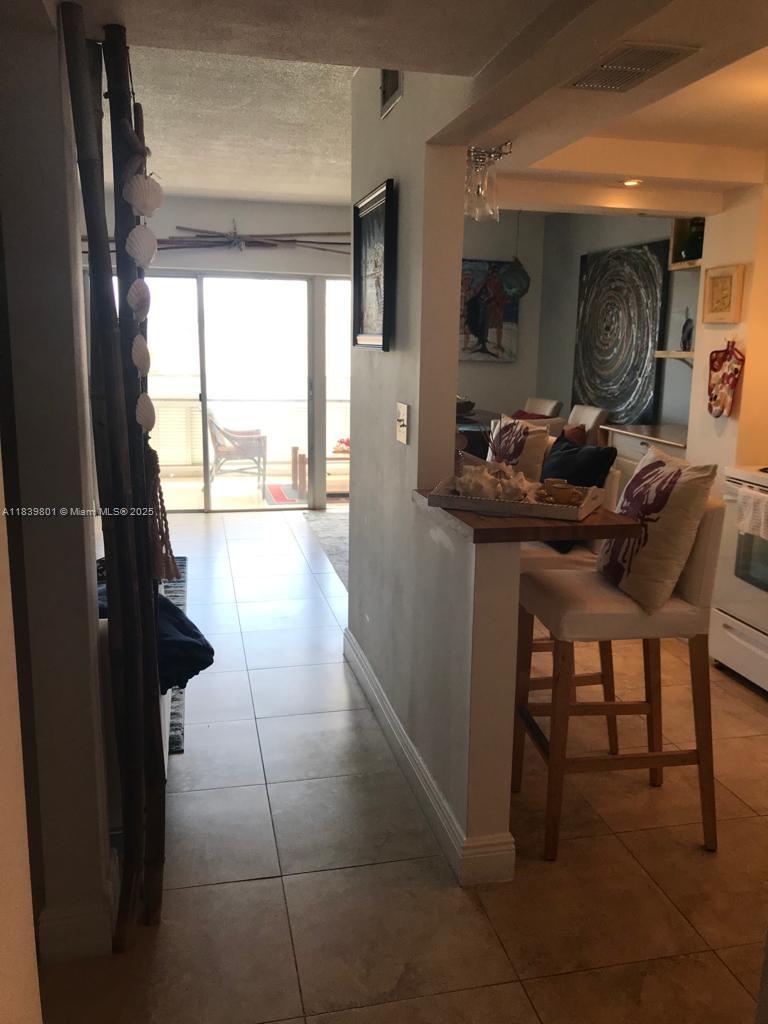 320 South Surf Road, Unit 305 Hollywood, FL 33019 - Photo 10 of 32 a living room with furniture and a large window