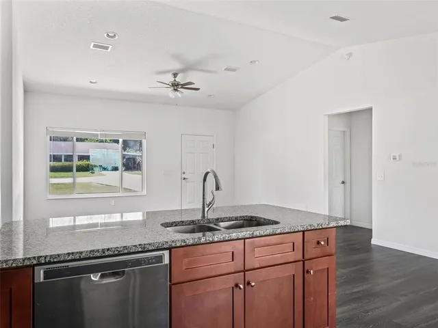 a kitchen with granite countertop a sink and a window