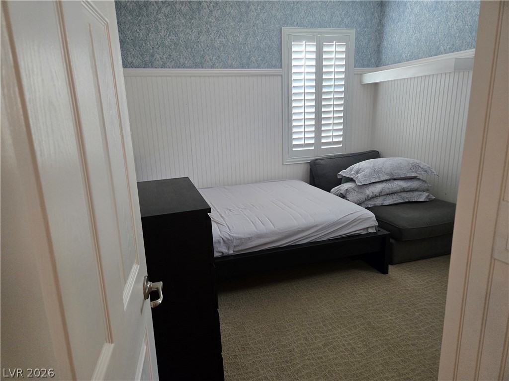 3144 Whitfeild Avenue Henderson, NV 89044 - Photo 51 of 55 Well-lit room with wainscoting and classic window shutters, providing a cozy and inviting atmosphere.