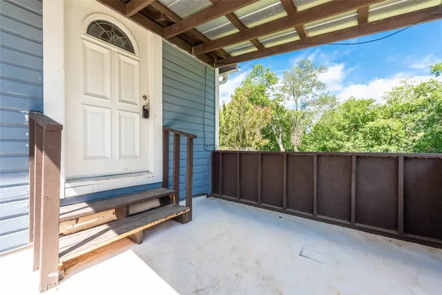 a view of backyard with wooden floor and a potted plant