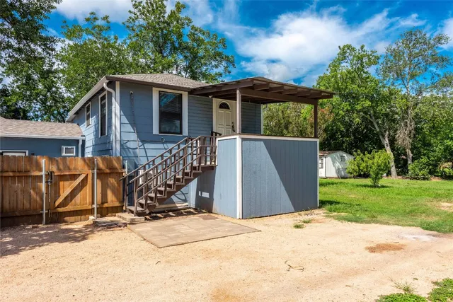 a view of a house with yard and sitting area