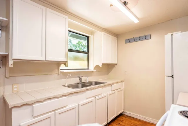 a kitchen with a sink cabinets and a window