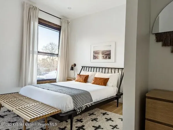 a bedroom with bed and wooden floor