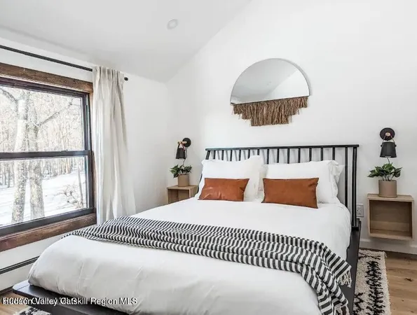 a bedroom with a large bed and a window