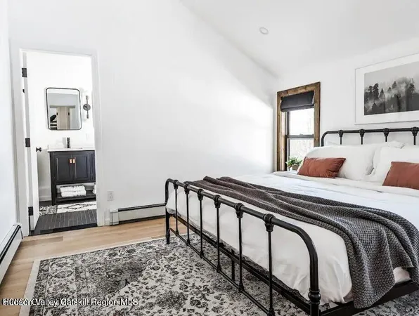 a bedroom with a bed and a television