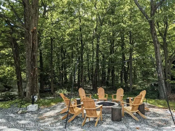 a backyard of a house with table and chairs