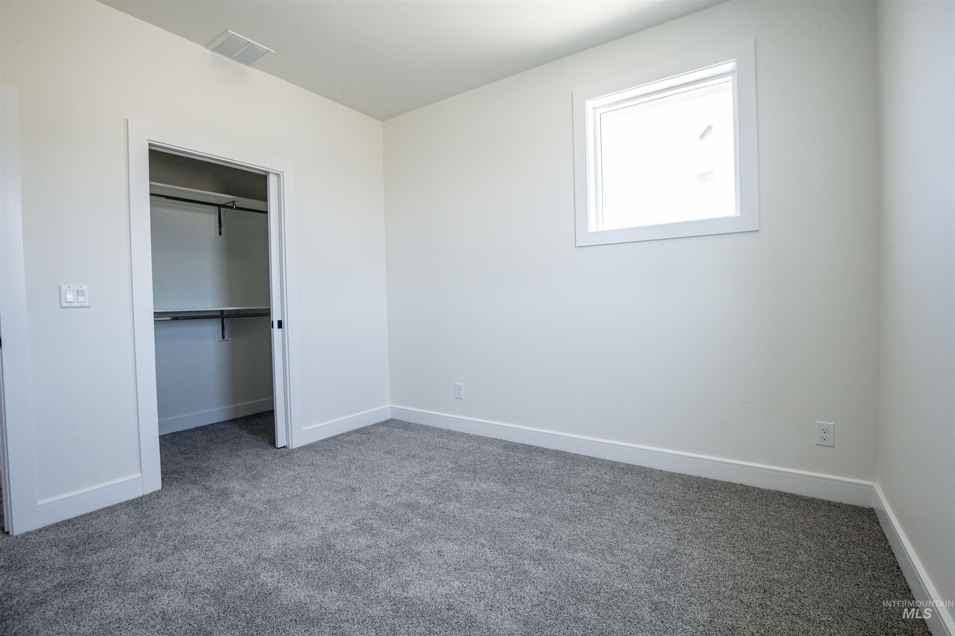 23904 Southview Lane Middleton, ID 83644 - Photo 15 of 29 Room featuring a large window, neutral wall paint, and gray carpet