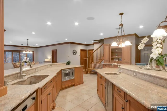 a dining room with furniture a chandelier and wooden floor