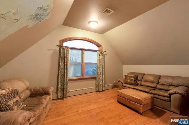 a living room with lots of furniture and a wooden floor