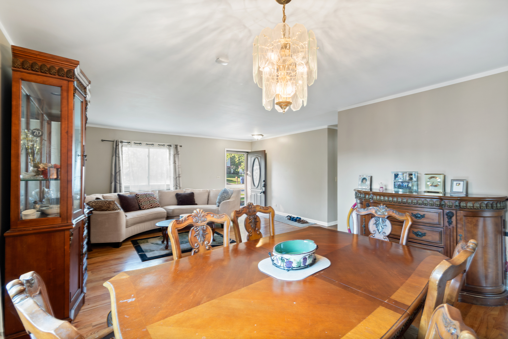 111 Deerpath Road Matteson, IL 60443 - Photo 7 of 23 a view of a dining room with furniture a chandelier and wooden floor