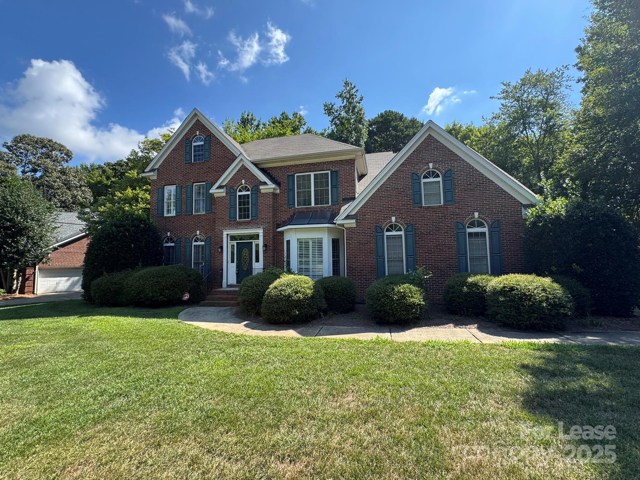 7127 Weddington Brook Drive Matthews, NC 28104 - Photo 1 of 31 a front view of a house with a garden and yard