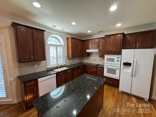 a kitchen with wooden cabinets and stainless steel appliances
