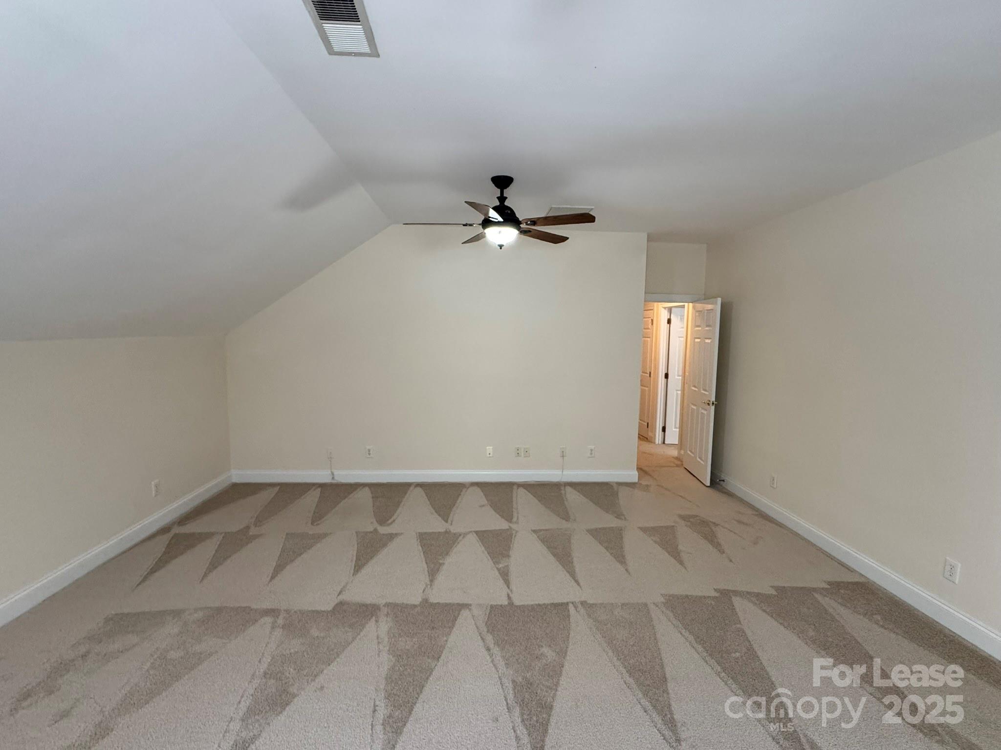 7127 Weddington Brook Drive Matthews, NC 28104 - Photo 19 of 31 an empty room with windows and fan